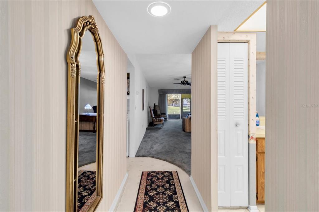 11204 Pembridge Court, Unit 4 Port Richey, FL 34668 - Photo 4 of 58 a view of a bathroom from a hallway