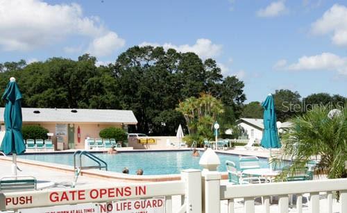 11204 Pembridge Court, Unit 4 Port Richey, FL 34668 - Photo 45 of 58 a view of a water fountain and a building in the background