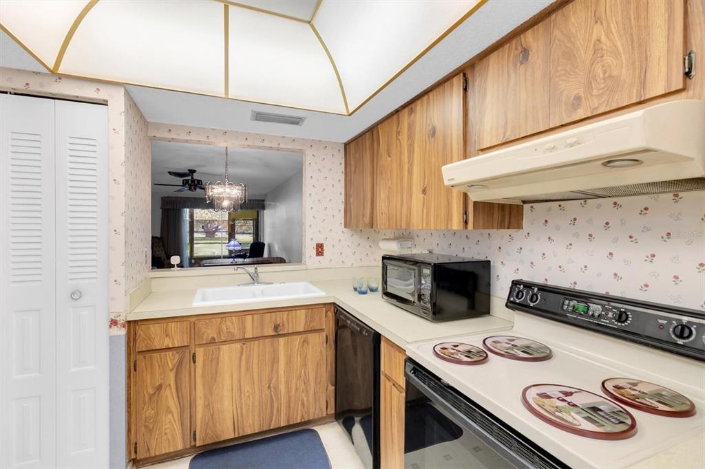 11204 Pembridge Court, Unit 4 Port Richey, FL 34668 - Photo 10 of 58 a kitchen with a stove and a white refrigerator