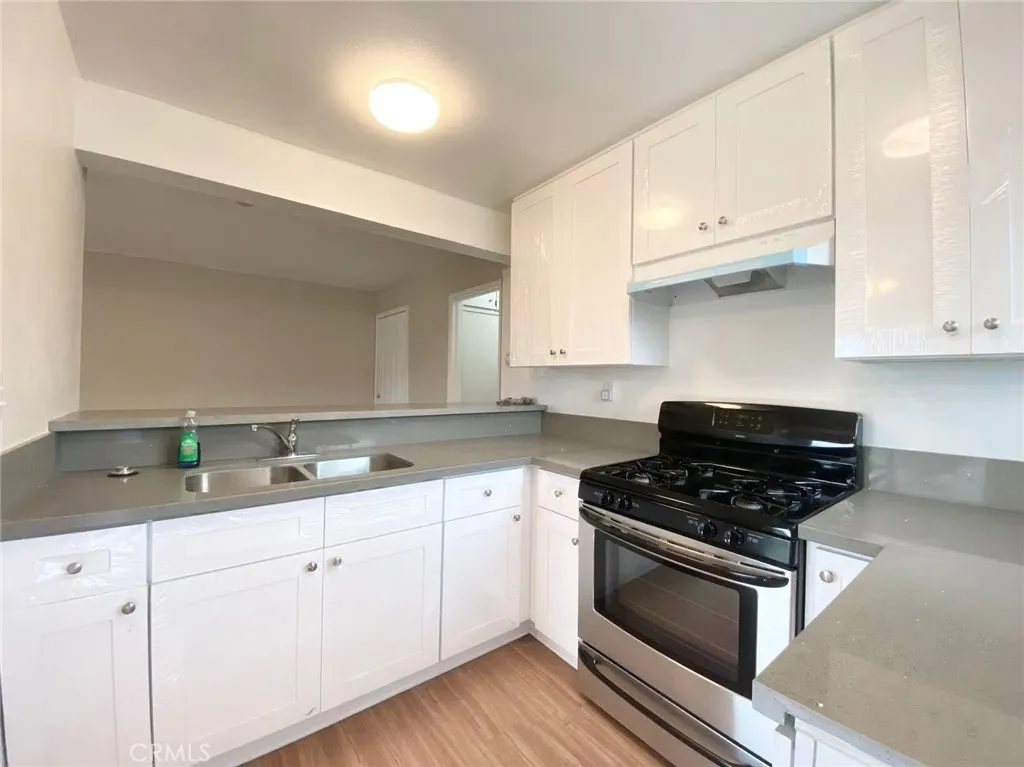 620 East 6th Street Azusa, CA 91702 - Photo 22 of 37 a kitchen with white cabinets and appliances
