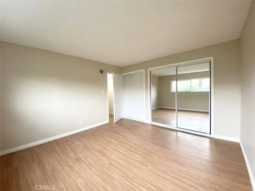 620 East 6th Street Azusa, CA 91702 - Photo 3 of 37 a view of an empty room with wooden floor and a window