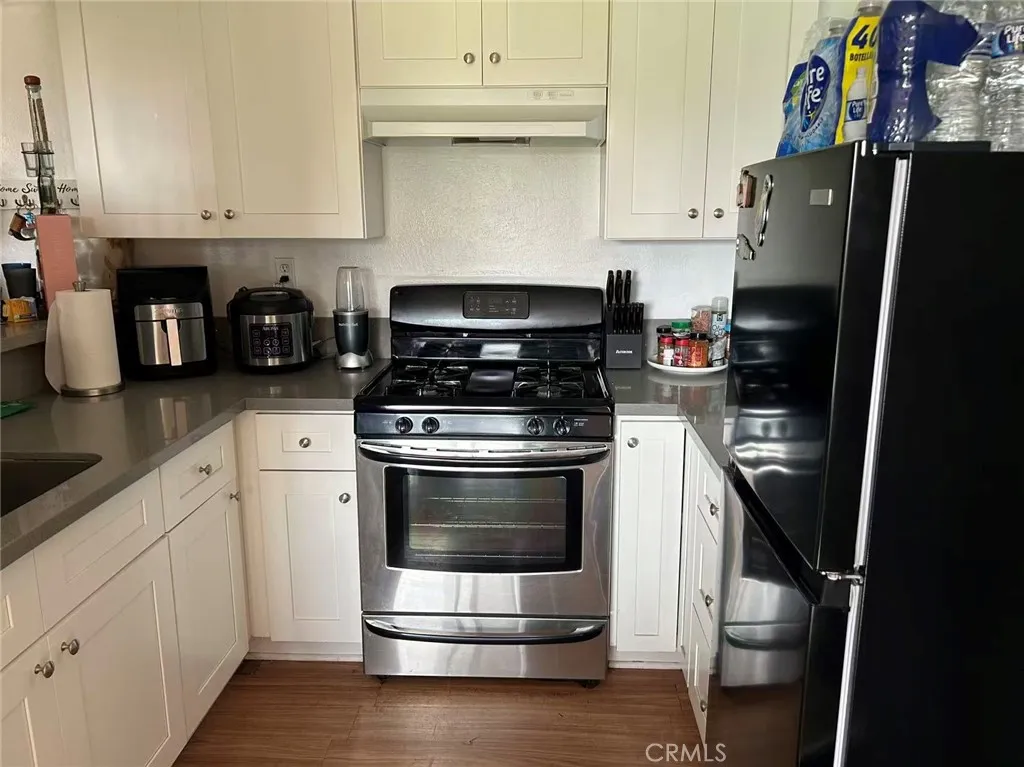 620 East 6th Street Azusa, CA 91702 - Photo 31 of 37 a kitchen with stainless steel appliances and wooden cabinets