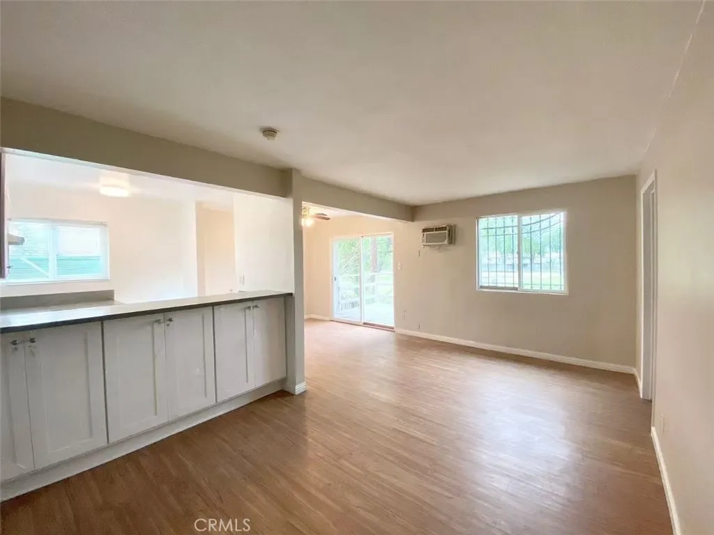 620 East 6th Street Azusa, CA 91702 - Photo 4 of 37 a view of an empty room with wooden floor and a window