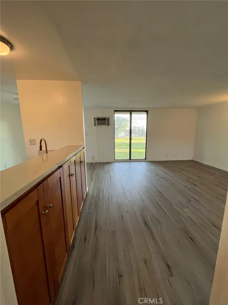 620 East 6th Street Azusa, CA 91702 - Photo 6 of 37 a view of an empty room with wooden floor and a window