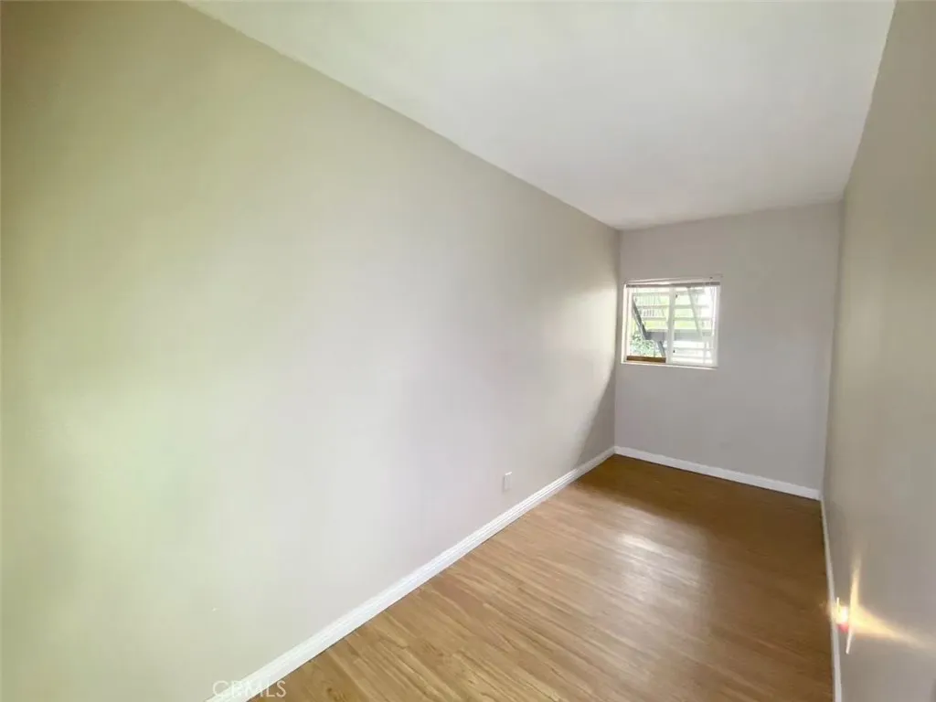 620 East 6th Street Azusa, CA 91702 - Photo 7 of 37 an empty room with wooden floor and windows