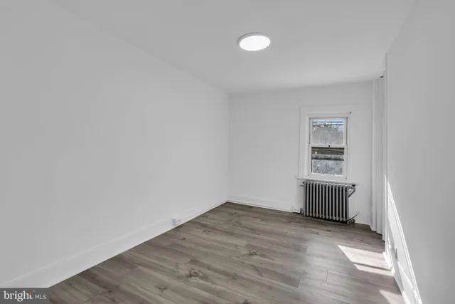a view of a room with wooden floor and sink