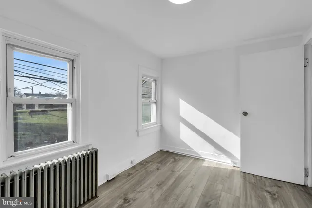 a view of a room with wooden floor and windows