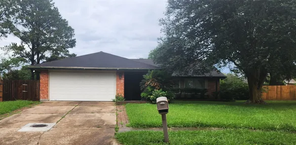 a front view of a house with a yard and a garage