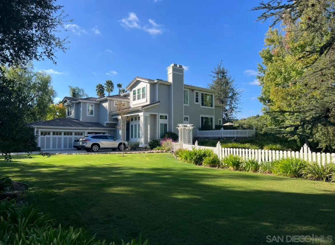a view of a house with a big yard next to a house