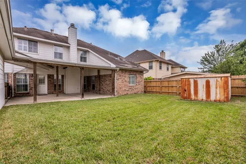 a view of a house with backyard and porch