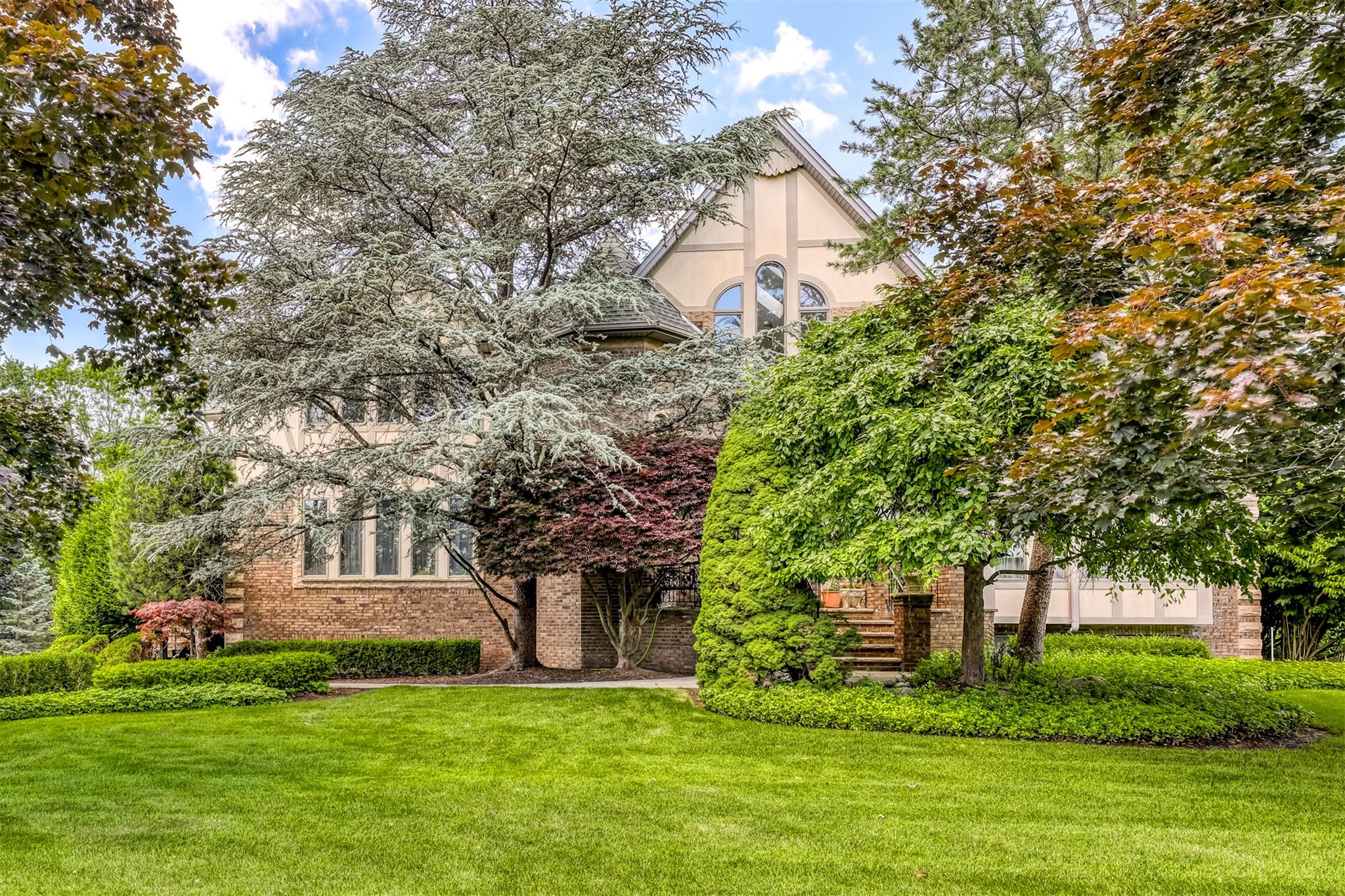 a front view of a house with a garden