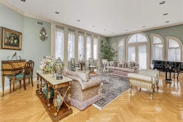 a living room with fireplace furniture and a large window