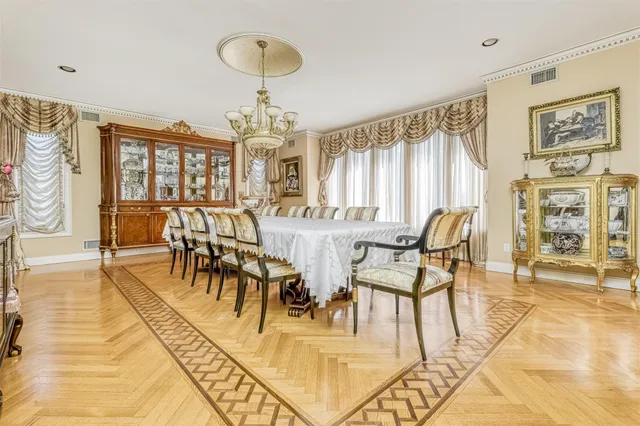 a view of a dining room with furniture and chandelier