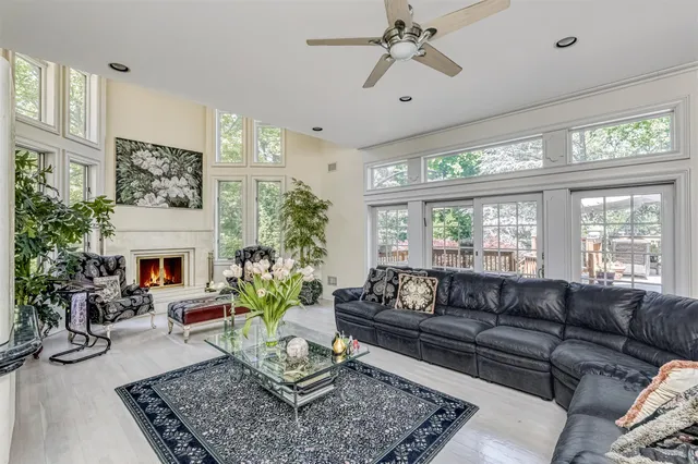 a living room with furniture a fireplace and a large window