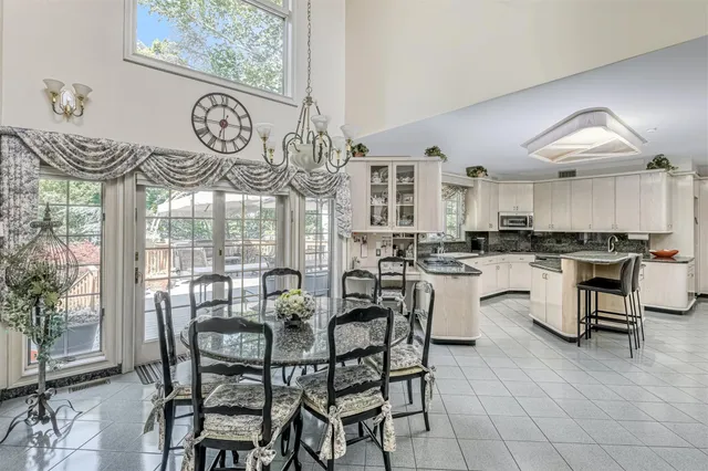 a dining area with furniture and a large window