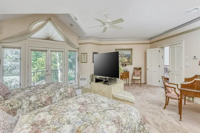 a bedroom with furniture and a flat screen tv