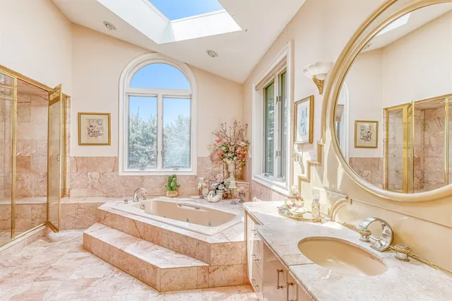 a spacious bathroom with a granite countertop tub sink and mirror