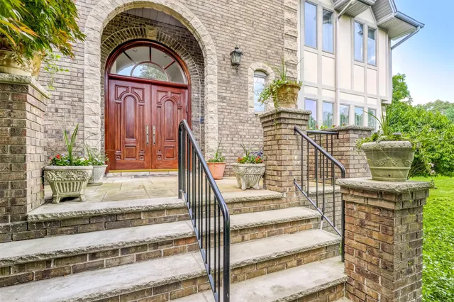 a front view of a house with a garden