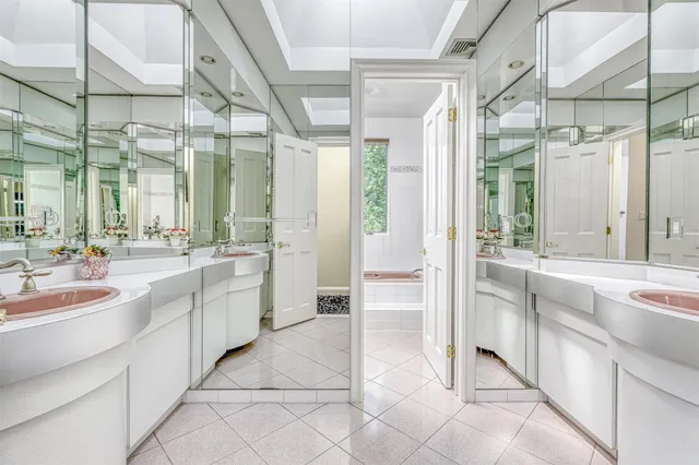a large kitchen with a sink and cabinets