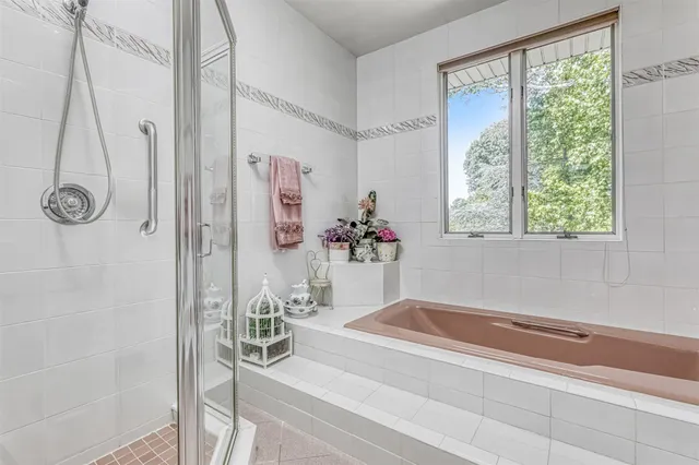 a bath room with a bath tub and a shower
