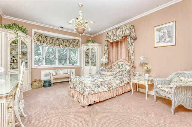 a spacious bedroom with a bed and a chandelier
