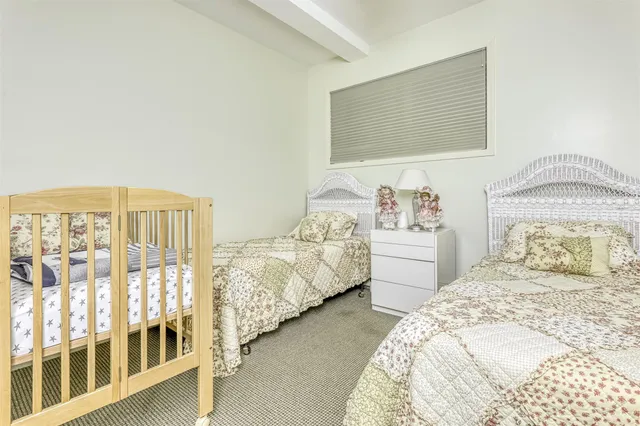 a bedroom with double bed and a window