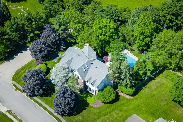 an aerial view of a house with a yard and black garden