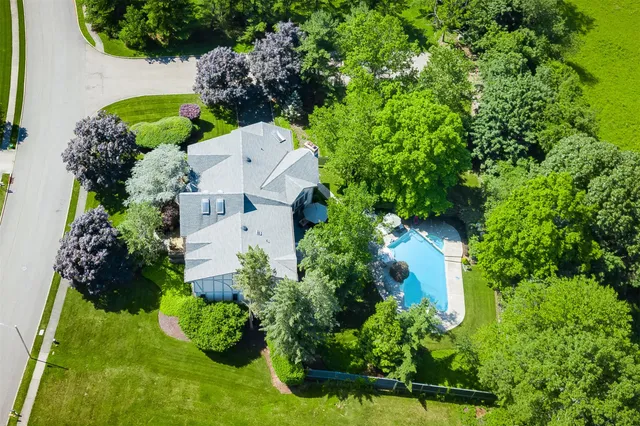 an aerial view of a house with a yard