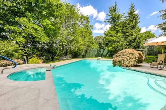 a view of a backyard with swimming pool