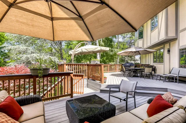 a view of a patio with couches chairs and umbrella