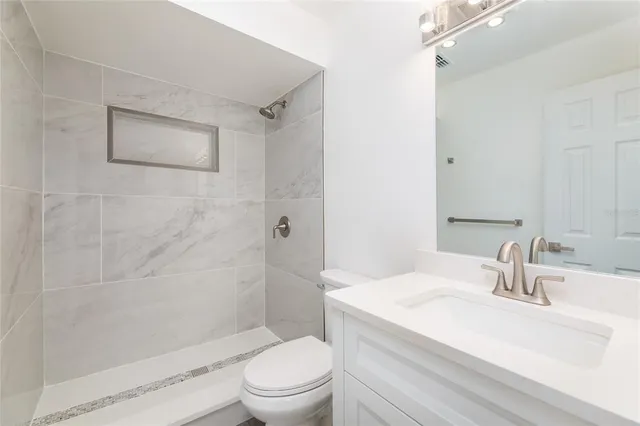 a bathroom with a sink toilet and shower