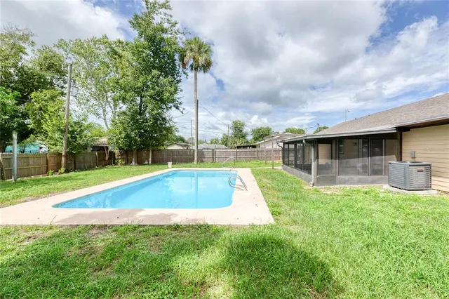 a view of a backyard with swimming pool