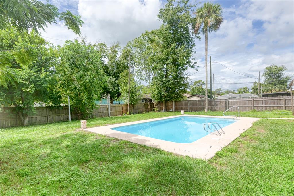 4975 Fay Boulevard Cocoa, FL 32927 - Photo 26 of 35 a view of a swimming pool with a yard