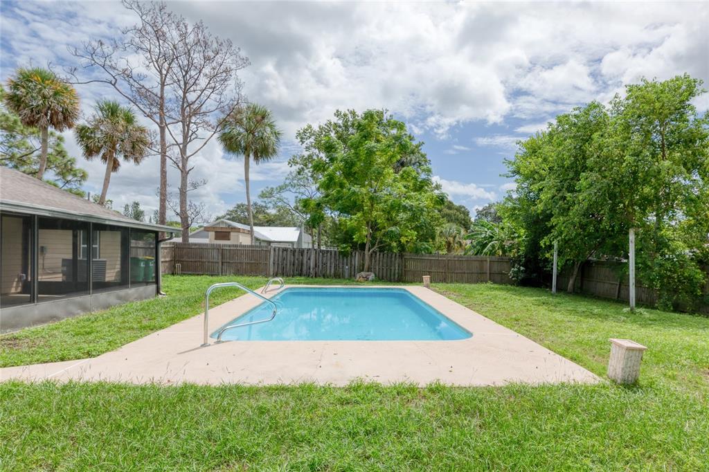 4975 Fay Boulevard Cocoa, FL 32927 - Photo 27 of 35 a small yard with lots of green space and palm trees