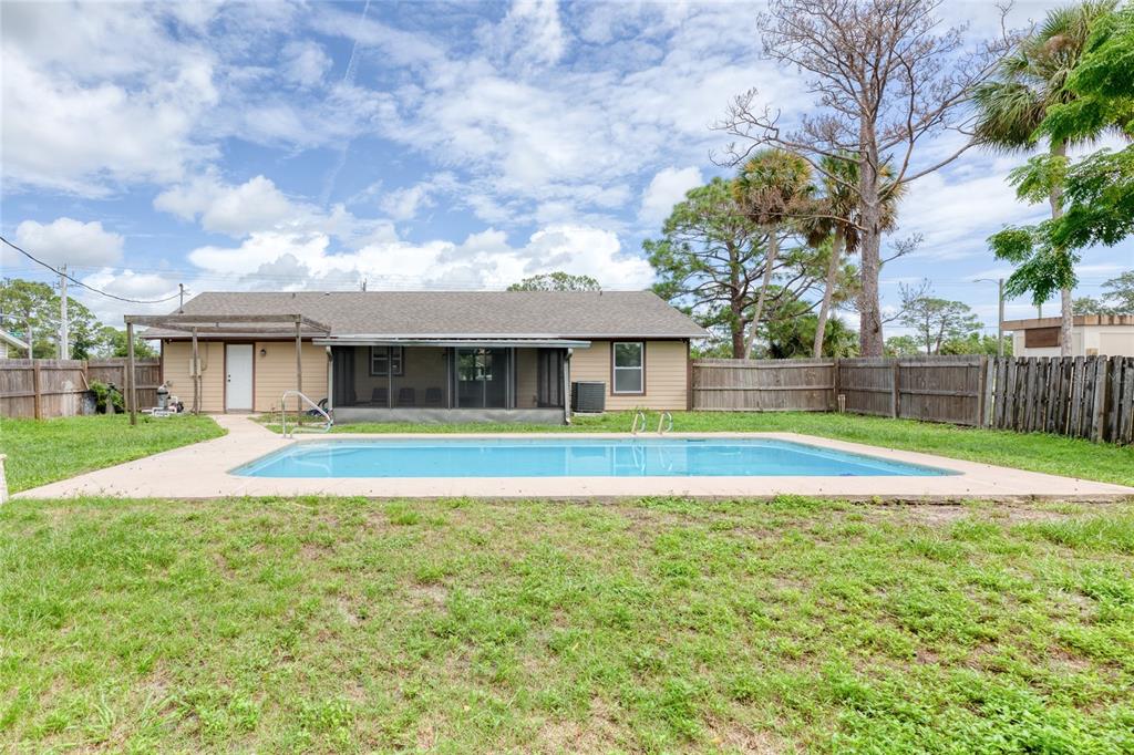 4975 Fay Boulevard Cocoa, FL 32927 - Photo 28 of 35 a view of pool with a big yard and large trees