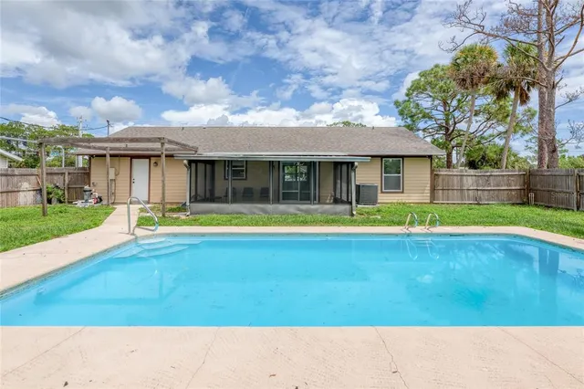 a view of swimming pool in front of house