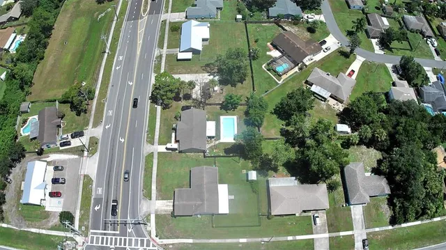 an aerial view of a residential apartment building with a yard and potted plants