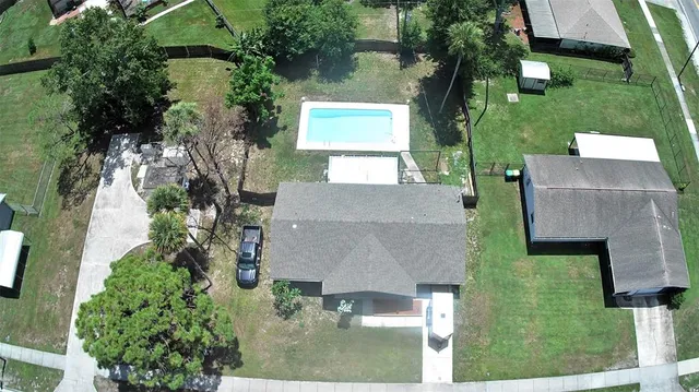 an aerial view of a house with a yard