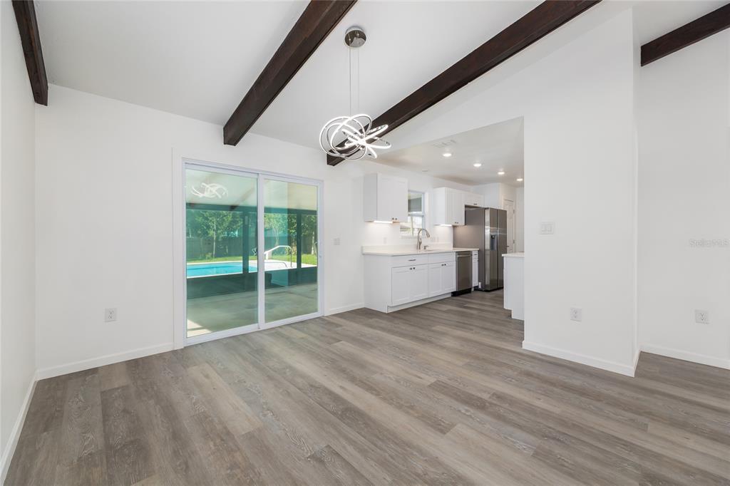 4975 Fay Boulevard Cocoa, FL 32927 - Photo 7 of 35 a view of an empty room with a kitchen