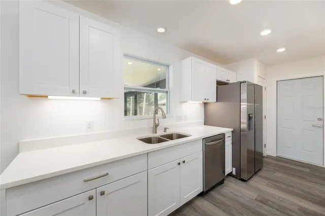 a kitchen with a sink and refrigerator