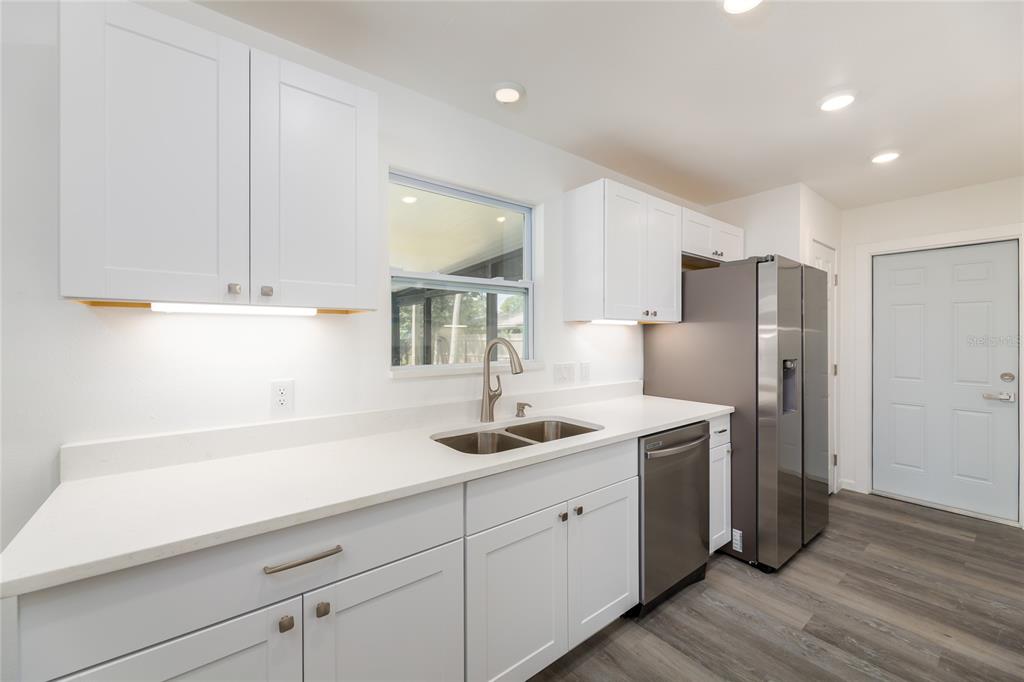 4975 Fay Boulevard Cocoa, FL 32927 - Photo 9 of 35 a kitchen with a sink and refrigerator