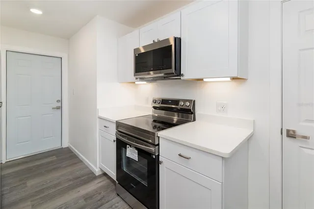 a kitchen with a stove and a microwave