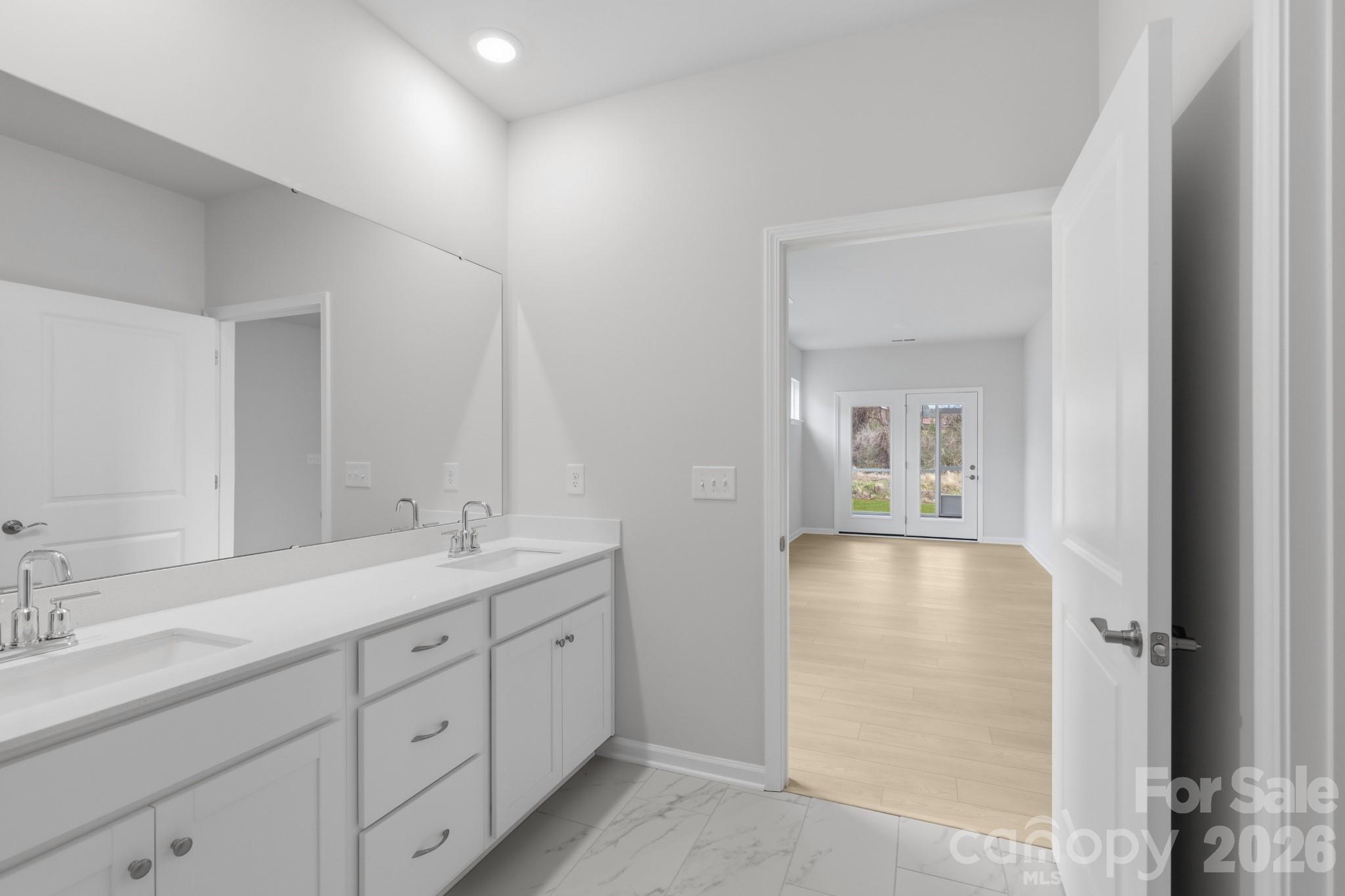 5450 Redbud Road, Unit 66 Lancaster, SC 29720 - Photo 28 of 35 a spacious bathroom with a double vanity sink and mirror