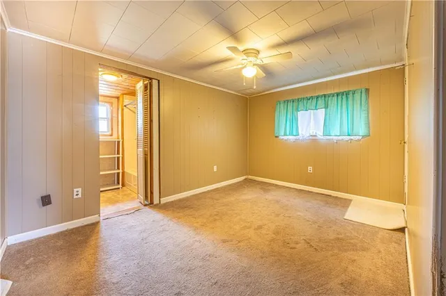 an empty room with a empty space and a ceiling fan
