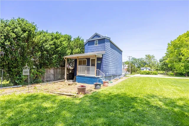 a view of a house with pool and a yard