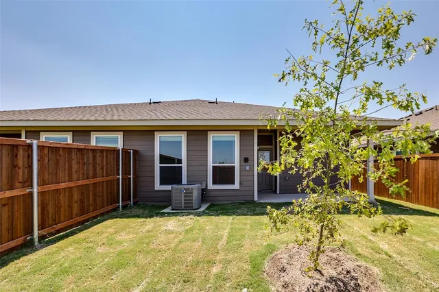 front view of a house with a large tree