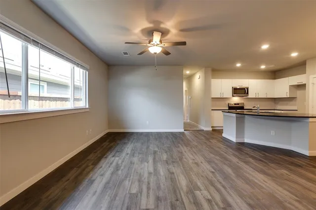 a view of kitchen with sink and wooden floor