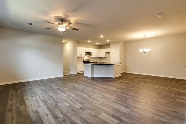 a view of a kitchen with a sink and microwave