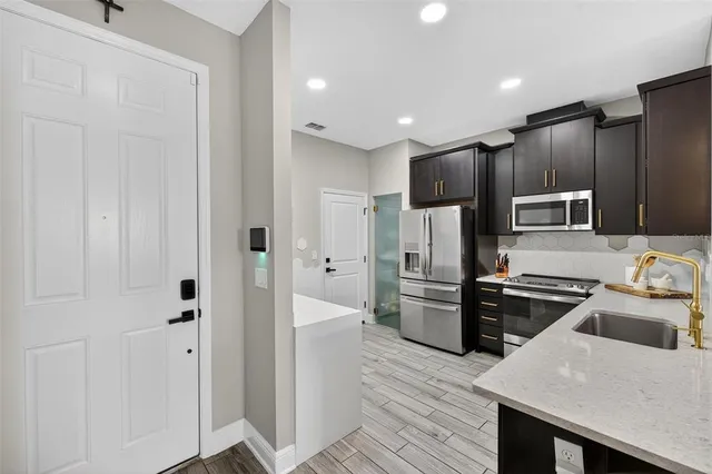 a living room with patio a couch and a potted plant
