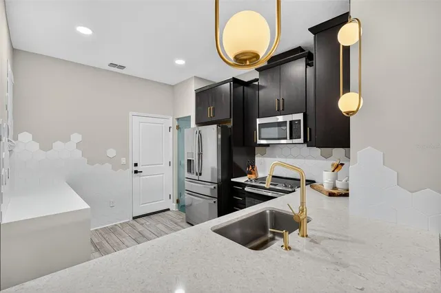 a view of a hallway with wooden floor and windows